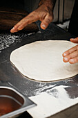 Pizza chef moulds pizza dough