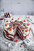 Chocolate cake with cream cream and cherries