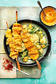 Saté skewers with coconut and rice salad and mango sauce