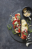 Focaccia sandwich with grilled peppers, feta and pine nuts