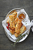 Feta dough rolls with honey and pine nuts
