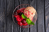 Cherry ice cream with berries and mint