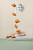 Flying biscuits with milk splashes and cutting board