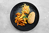Kiev cutlet with potato wedges and coleslaw
