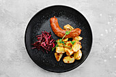 Bratwurst with fried potato wedges and beetroot salad