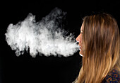 Woman exhaling vapour