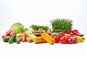 Various vegetables and herbs against a white background