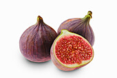 Whole and sliced figs against a white background