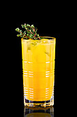 Orange lemonade with ice cubes and thyme