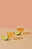 Tequila shots with salt rim and lime wedges
