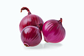 Three red onions against a white background