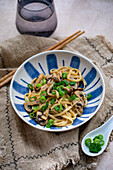 Udon noodles with mushrooms and spring onions