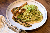 Chicken breast fillet with herbs and tagliatelle in parmesan cream sauce