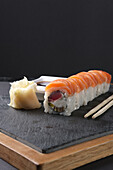 Sushi roll with salmon and tuna, ginger and wasabi
