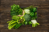 Various green vegetables in a wooden box