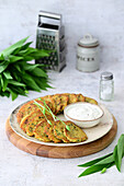 Draniki (potato pancakes from Belarus) with wild garlic and sour cream