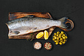 Raw ready-to-cook Chinook salmon on a chopping board