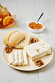Cream cheese with sultanas and walnuts with bread rolls and jam