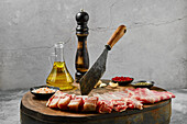 Raw lamb ribs with spices and olive oil on wooden board