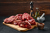 Raw pieces of lamb on wooden board