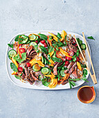 Thai beef salad with mango, glass noodles and mint