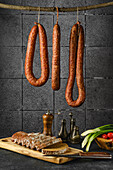 Smoked pork, beef and lamb sausage on a wooden stick