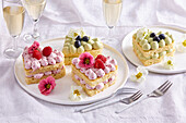 Heart-shaped mini cakes with cream and fresh fruit