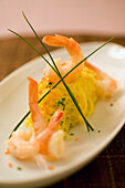 Prawns on saffron vermicelli with chives