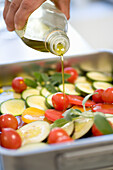 Pour olive oil over raw vegetable lasagne