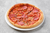 Pizza with pepperoni salami, tomato sauce and cheese