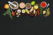 Various spices and herbs on a black background