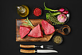 Raw tri-tip beef steaks with spices and herbs