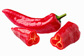 Whole and halved red peppers (Capia)