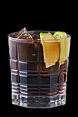 Cola with ice cubes and lime wedges