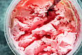 Red textured strawberry ice cream in the jar