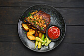 Grilled pork ribs with potato wedges and ketchup