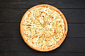 Classic pizza with dorblu cheese, pear and maple syrup, top view