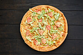 Pizza with squid, prawns, parmesan and lettuce leaves