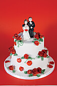 Wedding cake with roses and figurines