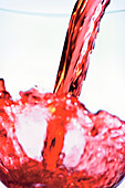 Pouring red wine into a glass, close-up