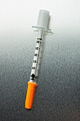 Medical syringe with orange cap