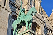 France, Paris, Montmartre, Sacre Coeur basilica, designed by architect Paul Abadie and completed in 1914, St Louis equestrian statue by sculptor Hippolyte Lefebvre