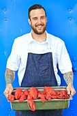 Canada, New Brunswick, Acadie, Moncton, Little Louis restaurant, Jonathan Morrisson cook with a shipment of lobsters
