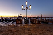 Italy, Veneto, Venice listed as World Heritage by UNESCO, San Marco district, Saint Mark's Square (Piazzetta San Marco), gondolas at Riva degli Schiavoni wharf, the basilica and abbey church of San Giorgio Maggiore in the background