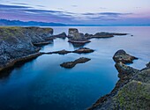 Iceland, Western Region, Grundafjordur, Arnarstapi, Snaefelness cliffs at sunset