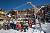 France, Haute Savoie, Chablais Massif, Portes du Soleil ski area, Avoriaz, lounge chairs on a restaurant bar terrace on the snow front in the center of the resort and contemporary wooden floor lamps
