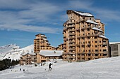 France, Haute Savoie, Chablais Massif, Portes du Soleil ski area, Avoriaz, a cross country skiing skier in front of the Malinka residence