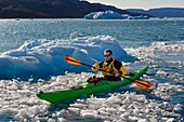 Greenland, west coast, Disko Bay, Quervain Bay, kayak progressing among icebergs