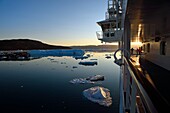 Greenland, west coast, Disko Bay, Hurtigruten's MS Fram Cruise Ship moves between Icebergs in Quervain Bay