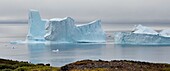 Greenland, west coast, Disko Island, Qeqertarsuaq, boat between two icebergs along the coast